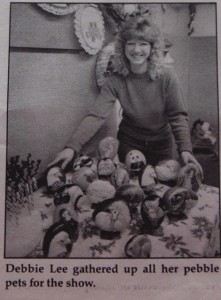 photo of artist with painted rocks