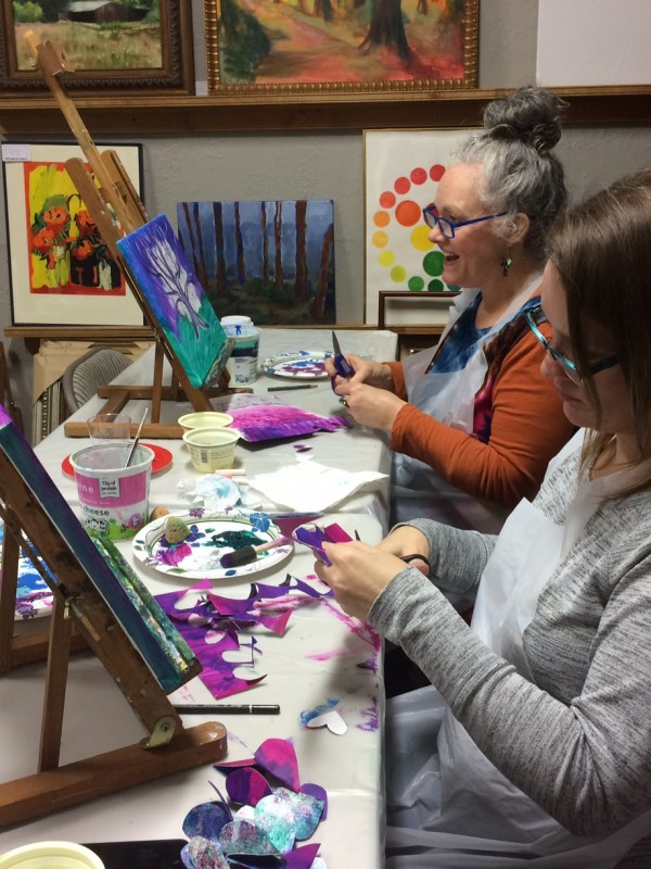 2 ladies working on painting