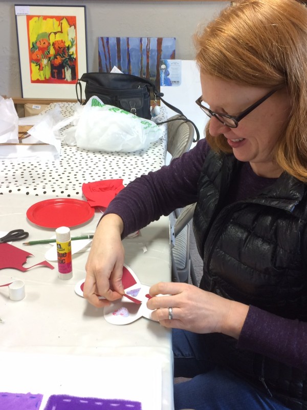 woman preparing stencil for fabric coloring