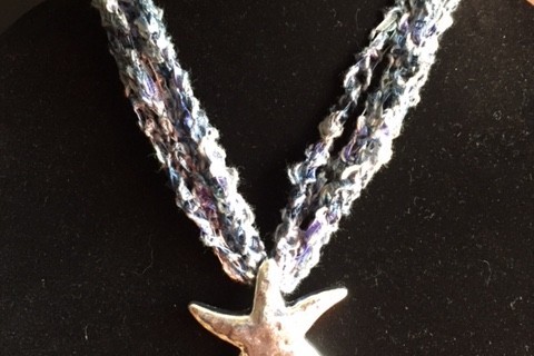 silver starfish in crocheted fabric