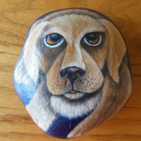 dog face painted on a rock