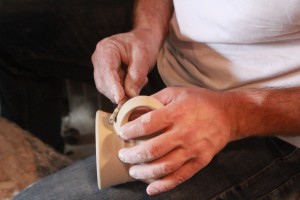 artist's hands smoothing ing the clay