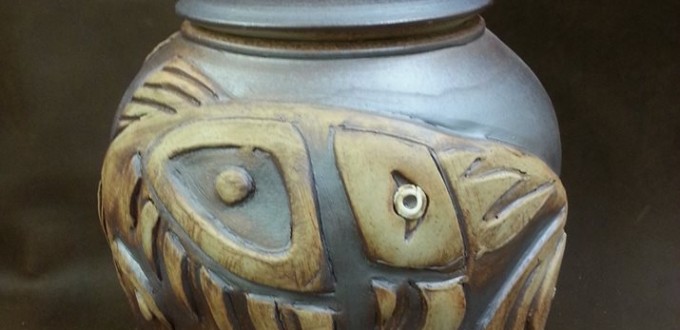 bear and fish images sculpted on urn