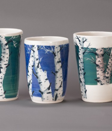 Blue and green tree designs on coffee mugs