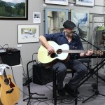 musician playing guitar at the gallery