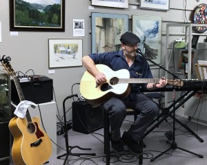 musician playing guitar at the gallery