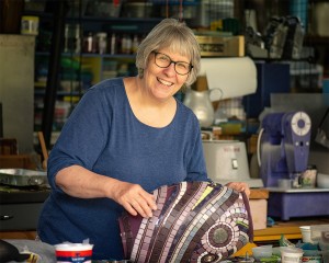 artist in front of her artwork