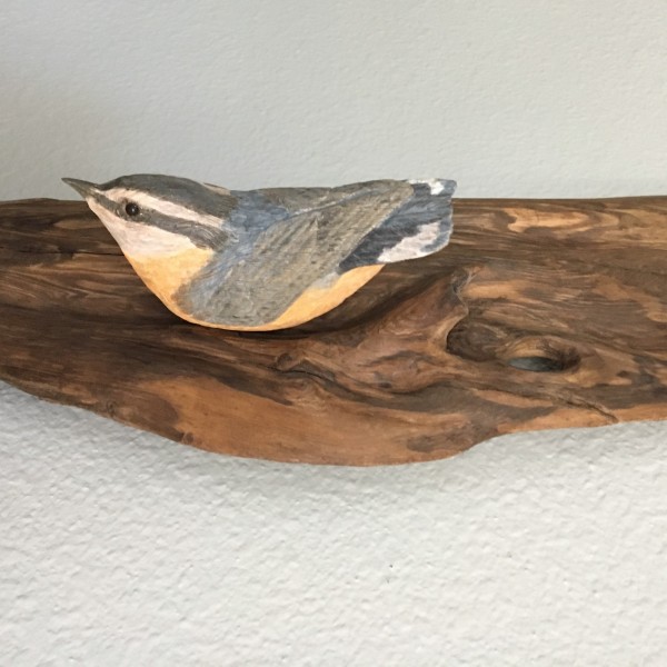 carved wren on wood