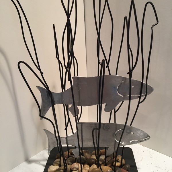2 metal fish shapes between wire reeds
