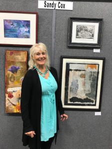 Sandy standing by her prints