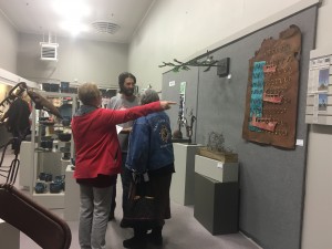 artist and 2 customers talking about art