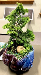 blue and violet handbuilt pottery with bonsai and other fauna