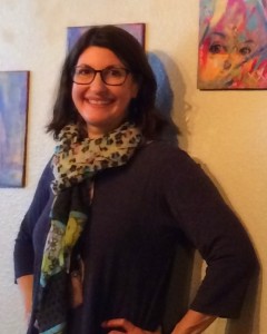 artist standing in front of artwork