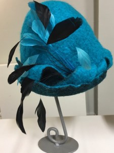 turquoise blue and black feathers on a felted hat