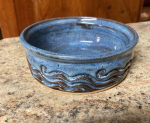 textured blue dish for wine bottle