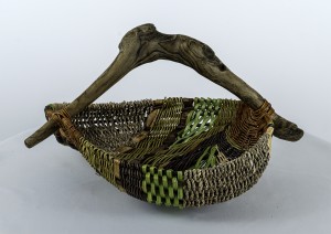 green, brown and gray woven basket with intr=egrated arched wood handle