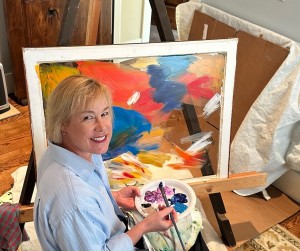 Artist painting a piece of glass