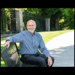 artist sitting on park bench