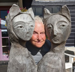 artist posed between two sculptures