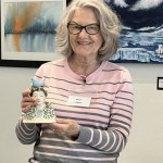 artist holding a small pottery sculpture