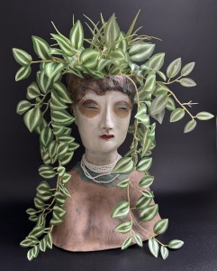 decorated wculpture with leaves and necklace