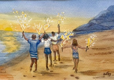 people carrying sparklers on the beach